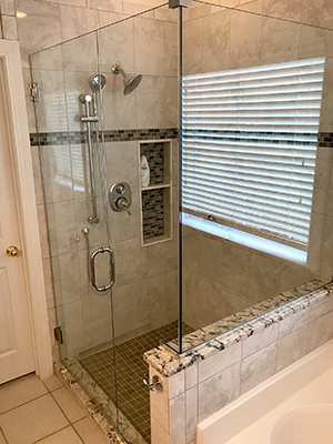 A bright bathroom finished with a custom glass shower door