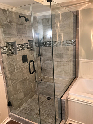 Glass shower door over a tub
