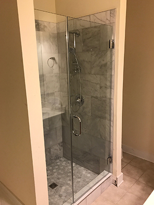 Glass shower door in a remodeled bath