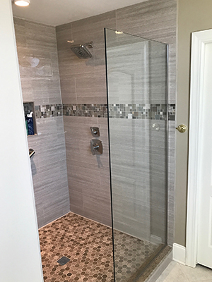 Semi-frameless shower door over a tub