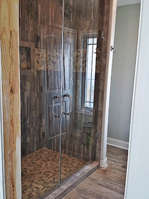 Frameless shower enclosure with modern fixtures