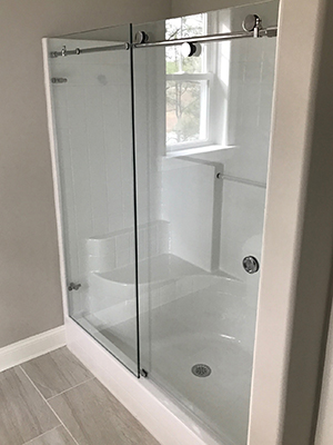Glass shower door with polished hardware