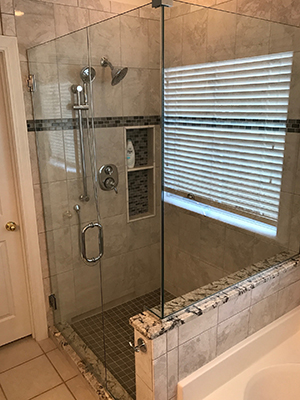 Custom shower enclosure with brushed hardware